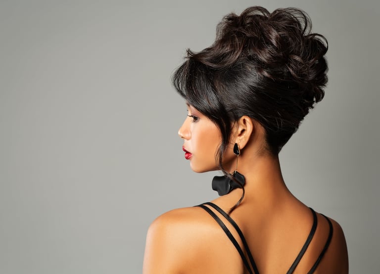 Beautiful woman with elegant wedding updo hair over gray background with black earrings and red lips