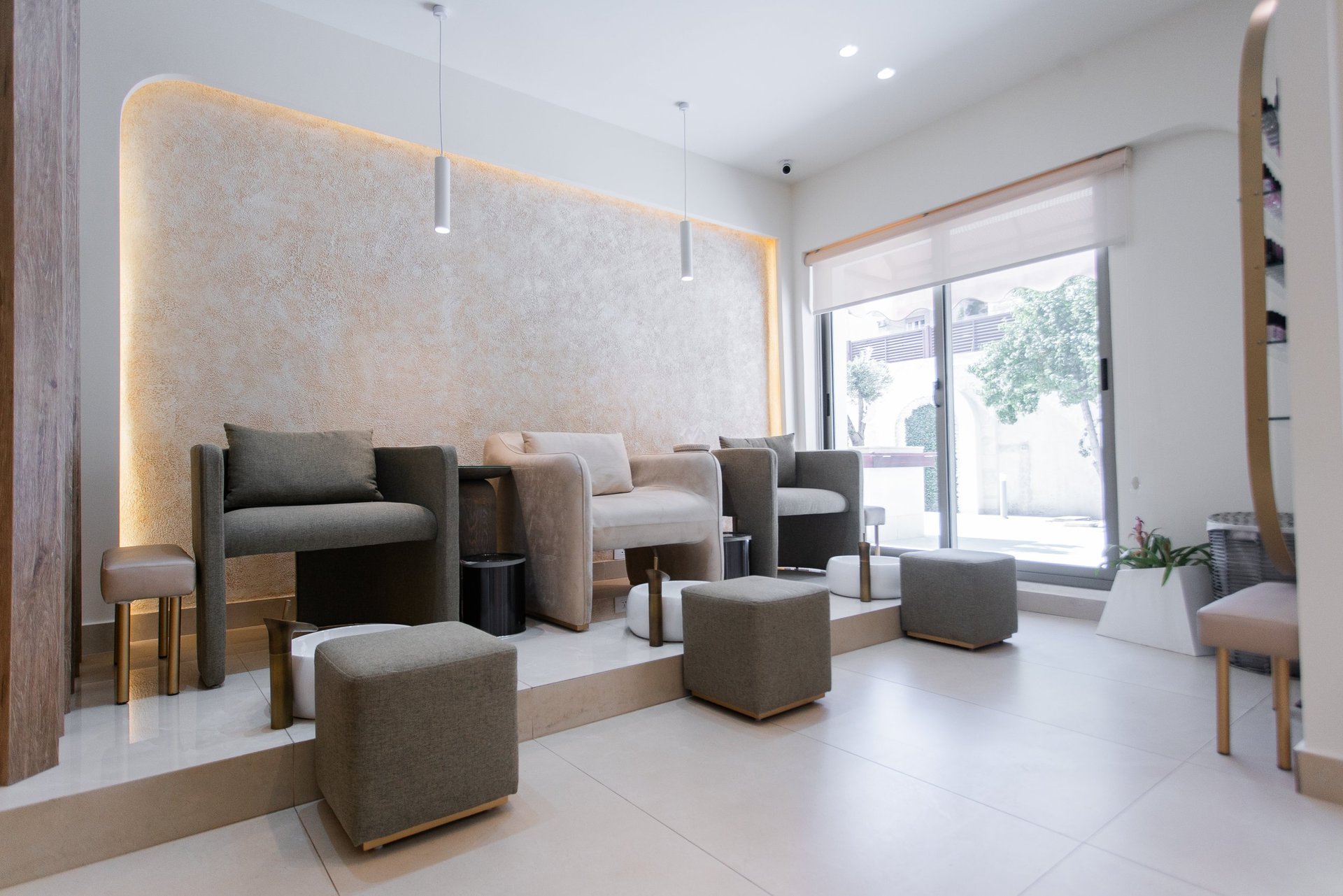 Modern minimalist salon interior with beige chairs and gold accents